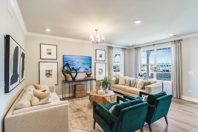 living room with crown molding, light hardwood / wood-style flooring, and a notable chandelier