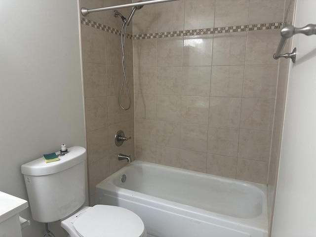 bathroom with bathtub / shower combination, vanity, and toilet