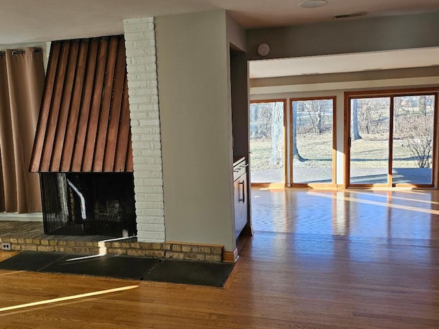 unfurnished living room with hardwood / wood-style flooring