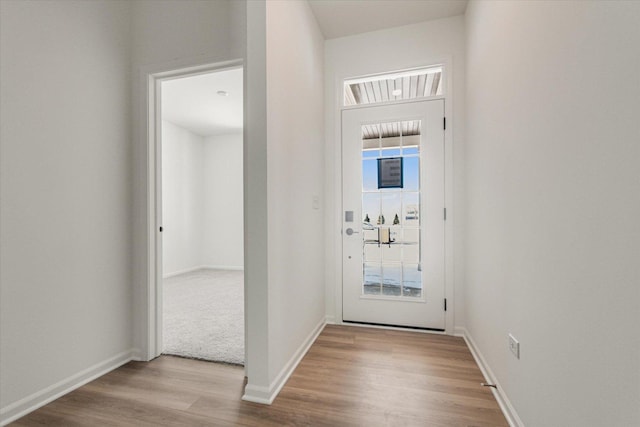 entryway with light wood-type flooring and baseboards