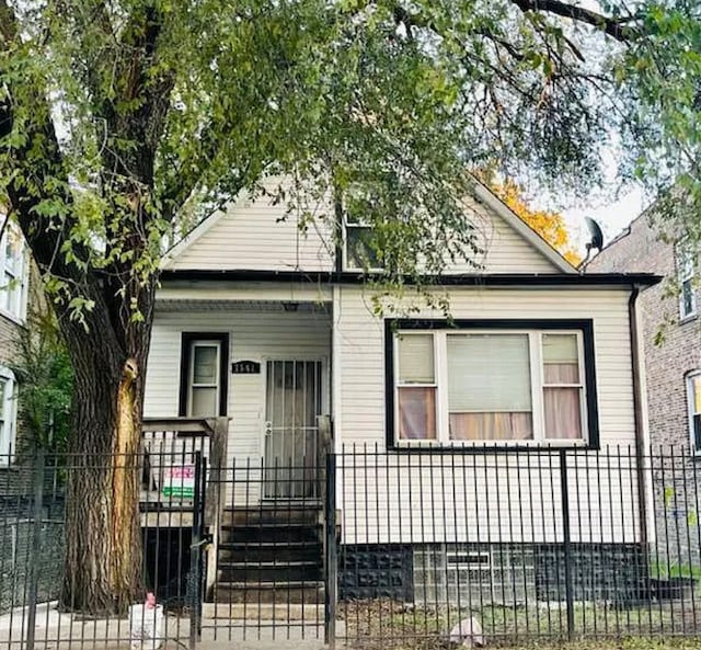 bungalow-style house with a fenced front yard