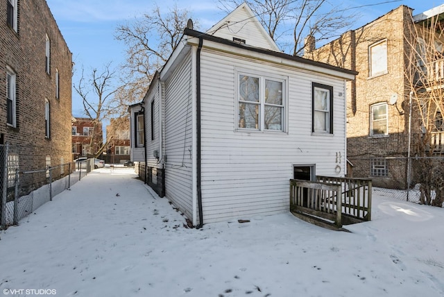 view of snow covered exterior featuring fence