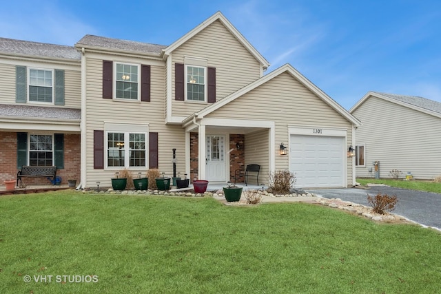 view of front of home featuring a garage and a front yard