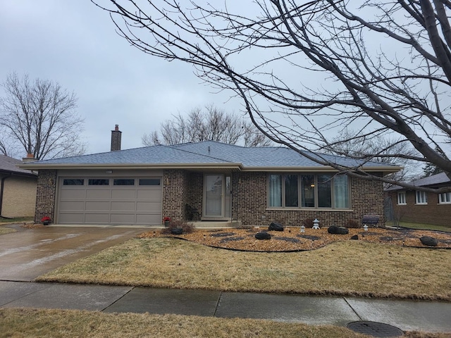 ranch-style house with a garage and a front yard