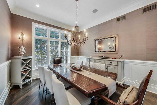 dining space featuring dark wood-type flooring, a wainscoted wall, visible vents, and crown molding