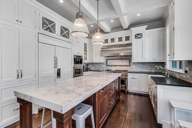 kitchen with oven, under cabinet range hood, white cabinetry, high end stainless steel range oven, and beamed ceiling