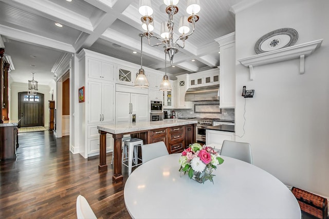 dining area featuring coffered ceiling, dark wood-type flooring, beamed ceiling, crown molding, and a chandelier