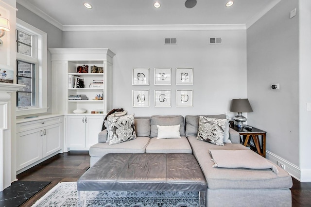 living area featuring visible vents, dark wood-type flooring, and ornamental molding