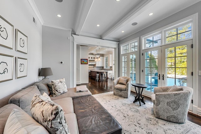 living room with french doors, wood finished floors, visible vents, and crown molding