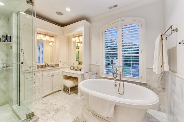 bathroom featuring a stall shower, visible vents, a soaking tub, marble finish floor, and vanity