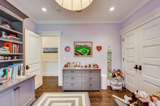 game room with dark wood-style floors, ornamental molding, and recessed lighting