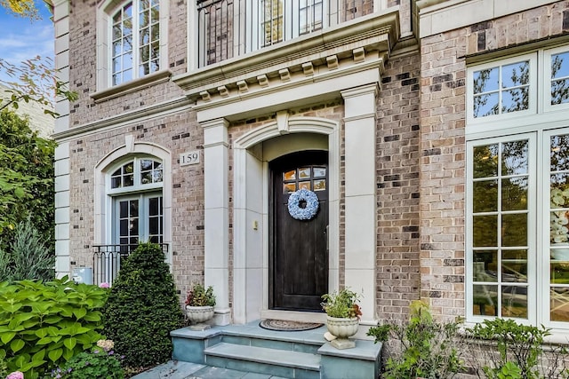 property entrance featuring brick siding