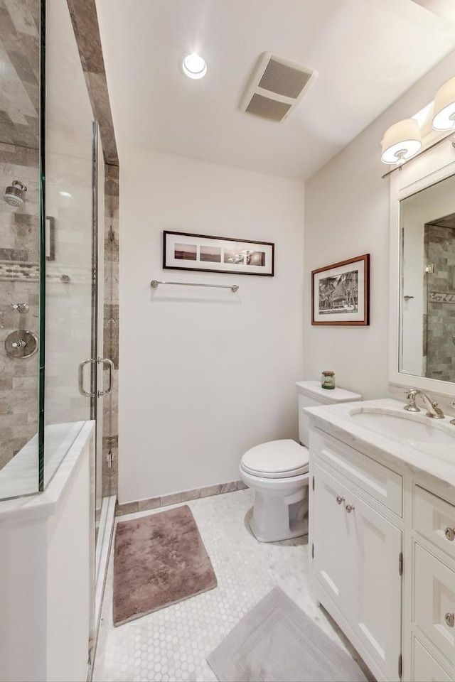 full bathroom with visible vents, toilet, tile patterned flooring, vanity, and a shower stall