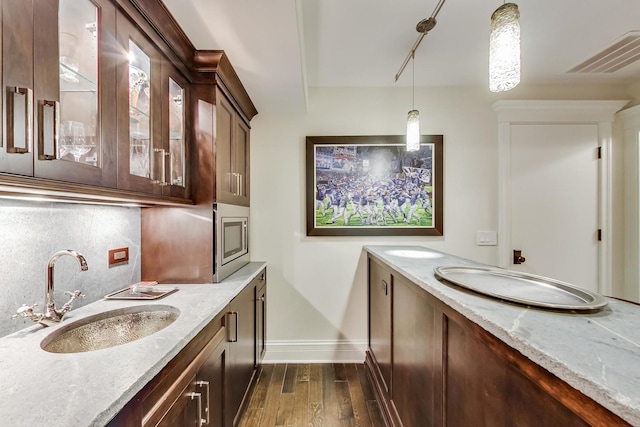 bathroom with tasteful backsplash, baseboards, visible vents, wood finished floors, and vanity