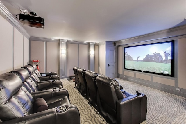 home theater with crown molding, carpet floors, baseboards, and a decorative wall