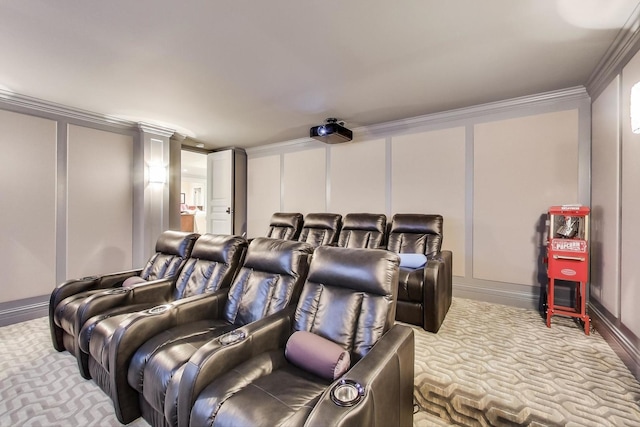 carpeted cinema room with decorative columns, a decorative wall, and crown molding