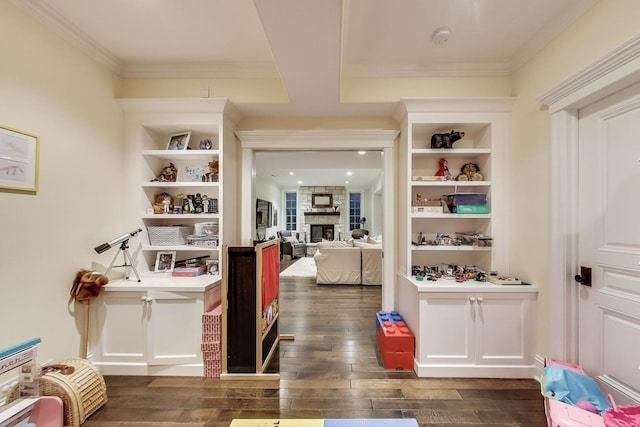 interior space with ornamental molding, dark wood finished floors, and built in shelves