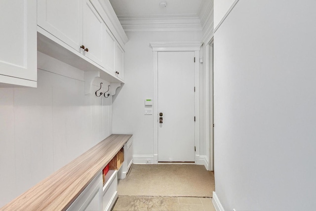 mudroom with baseboards, ornamental molding, and light colored carpet