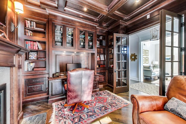 home office with wood walls, built in features, coffered ceiling, and crown molding