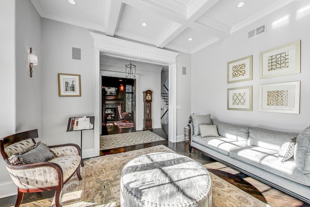 living area with visible vents, coffered ceiling, beamed ceiling, baseboards, and stairs