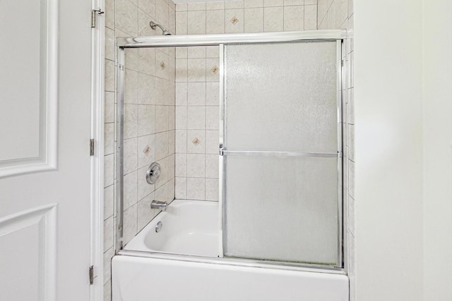 bathroom featuring shower / bath combination with glass door