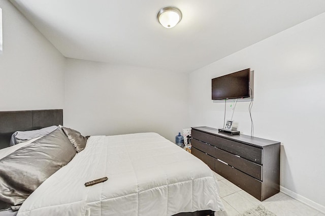 bedroom featuring light tile patterned flooring