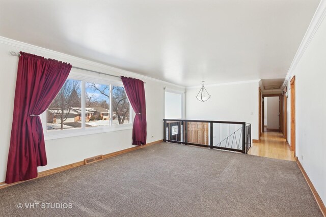 empty room with a ceiling fan, light wood-type flooring, visible vents, and baseboards