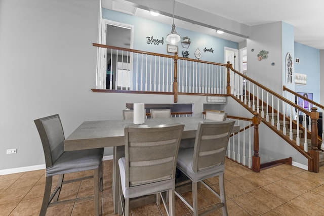 dining area with tile patterned flooring, stairs, and baseboards