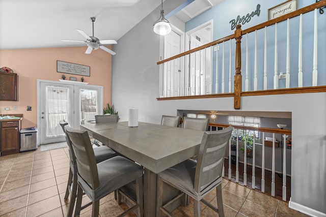 dining area featuring a healthy amount of sunlight, light tile patterned floors, and high vaulted ceiling