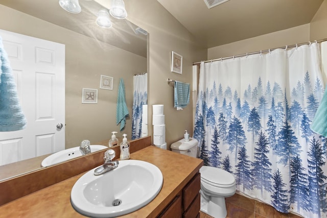 full bathroom featuring visible vents, toilet, lofted ceiling, tile patterned flooring, and vanity