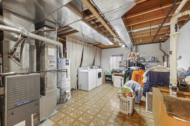 below grade area with light floors, separate washer and dryer, and gas water heater