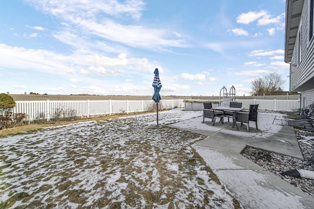 yard covered in snow with a fenced backyard