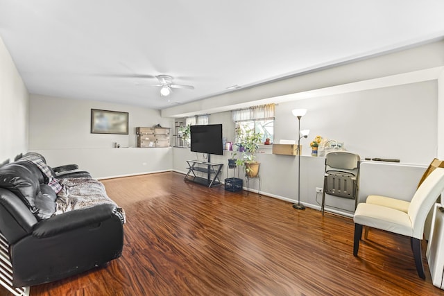 living area with ceiling fan, wood finished floors, and baseboards