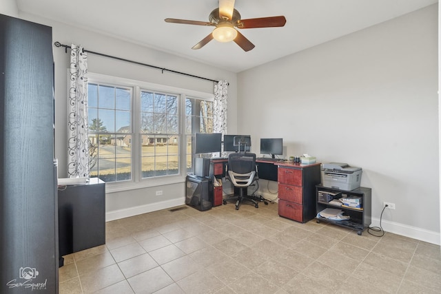 office space featuring ceiling fan and baseboards