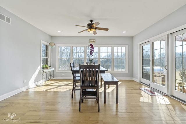 dining space featuring baseboards, wood finished floors, visible vents, and recessed lighting