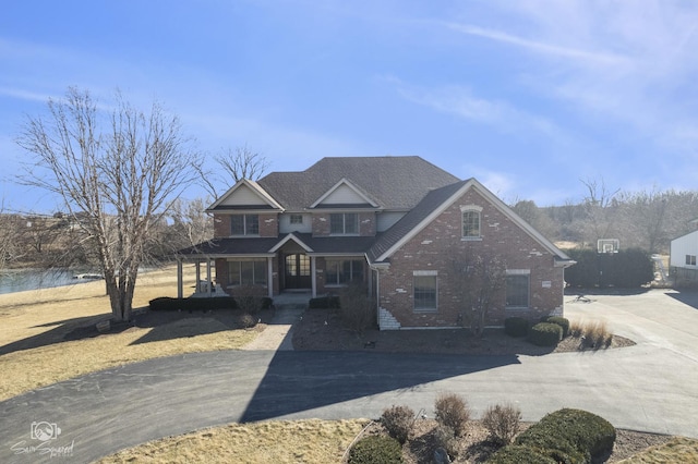 view of front facade featuring a porch and brick siding