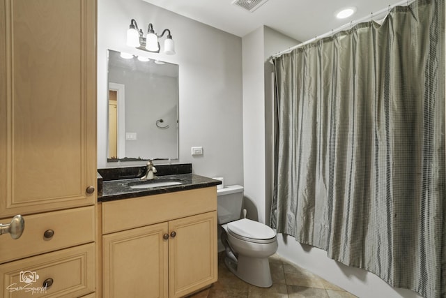 bathroom with visible vents, toilet, shower / bath combo, vanity, and tile patterned floors