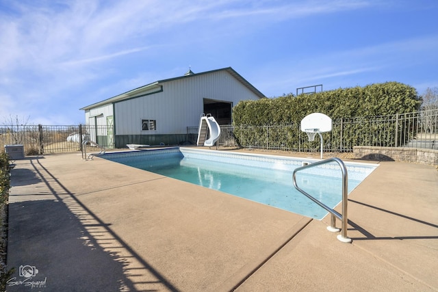 view of pool with a patio area, a fenced in pool, fence, and a water slide