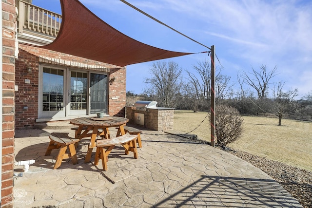 view of patio with french doors, exterior kitchen, area for grilling, and a balcony