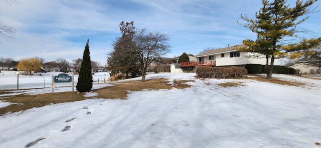 yard covered in snow featuring a deck