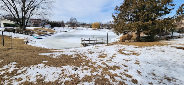 snowy yard featuring a garage