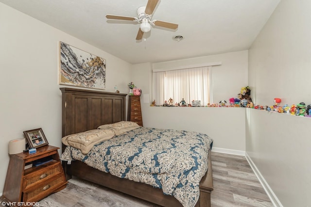 bedroom with ceiling fan and light wood-type flooring