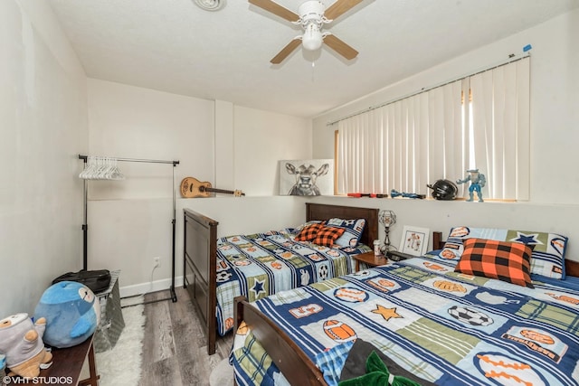 bedroom with ceiling fan and light hardwood / wood-style flooring