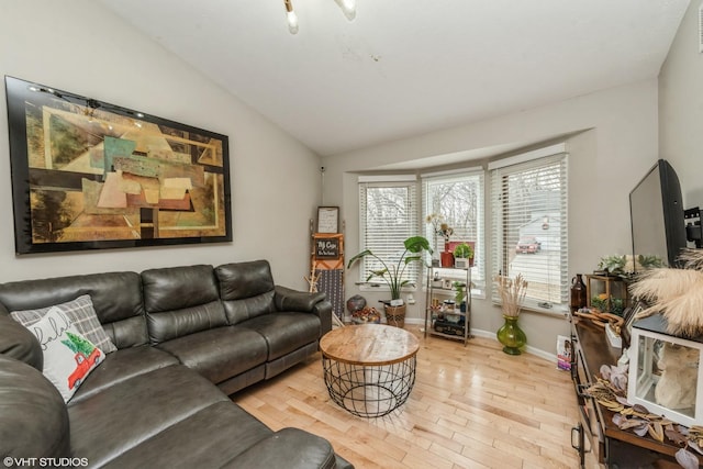 living room with lofted ceiling and light hardwood / wood-style flooring