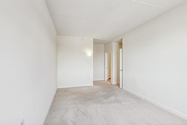 spare room featuring light colored carpet