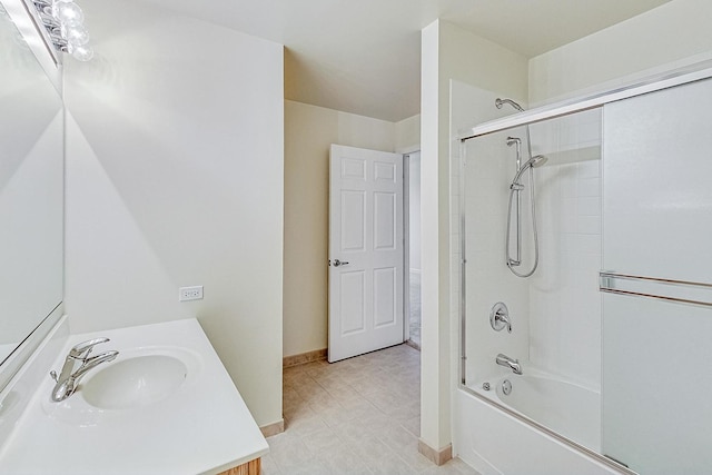 bathroom with vanity and bath / shower combo with glass door