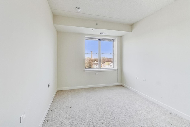 unfurnished room featuring light carpet