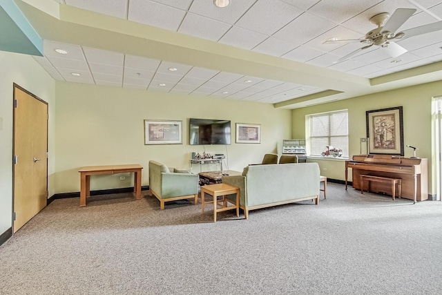 sitting room with carpet, a paneled ceiling, and ceiling fan