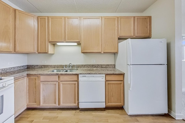 kitchen featuring light brown cabinetry, sink, light wood-type flooring, white appliances, and a textured ceiling