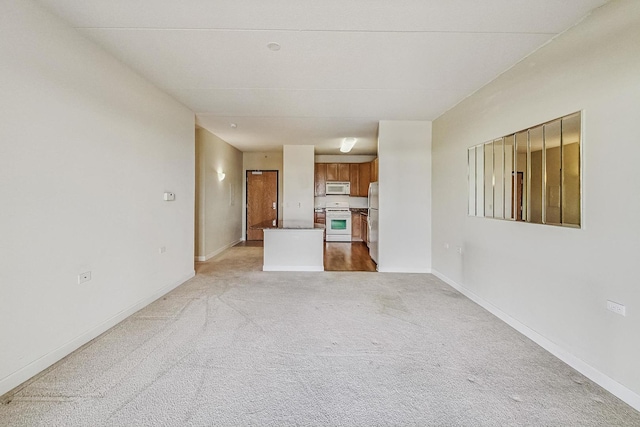 unfurnished living room with light carpet